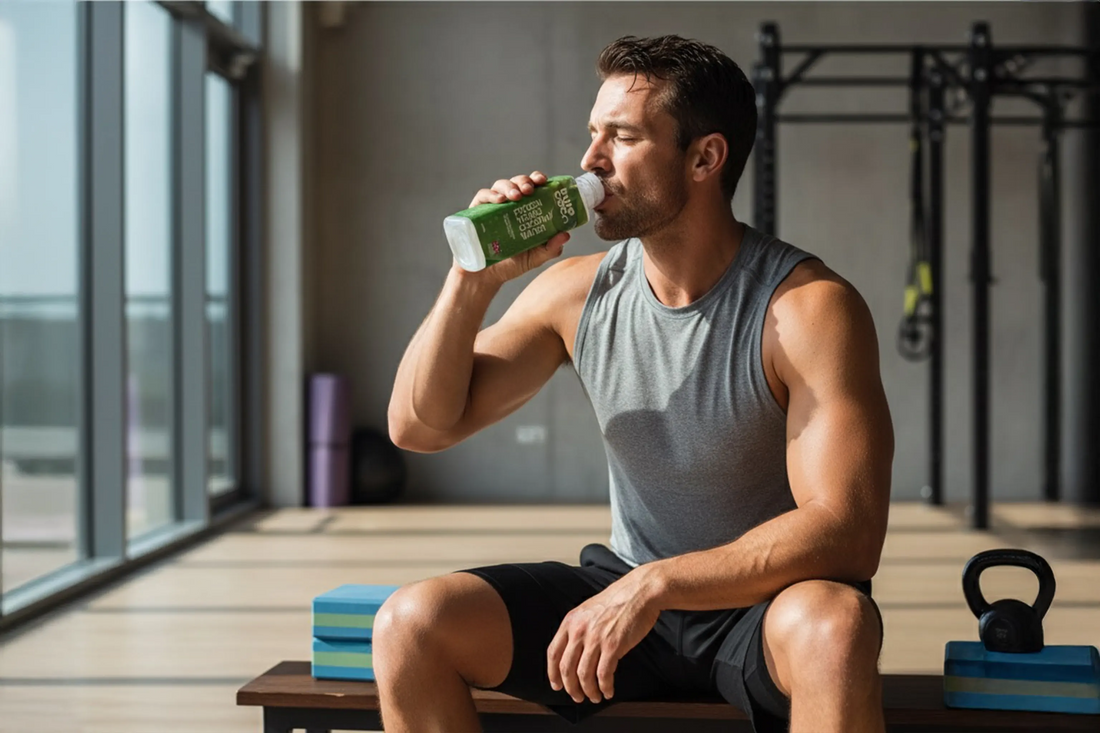 Man drinking coconut water after gym workout for natural hydration and muscle recovery in the UK