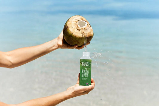 Natural coconut water hydration drink bottle at the beach UK