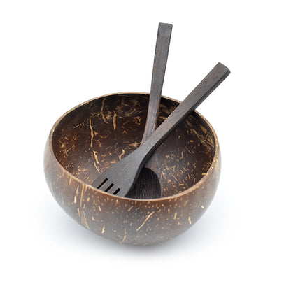 Handmade natural coconut shell bowl set with wooden spoon and fork on white background