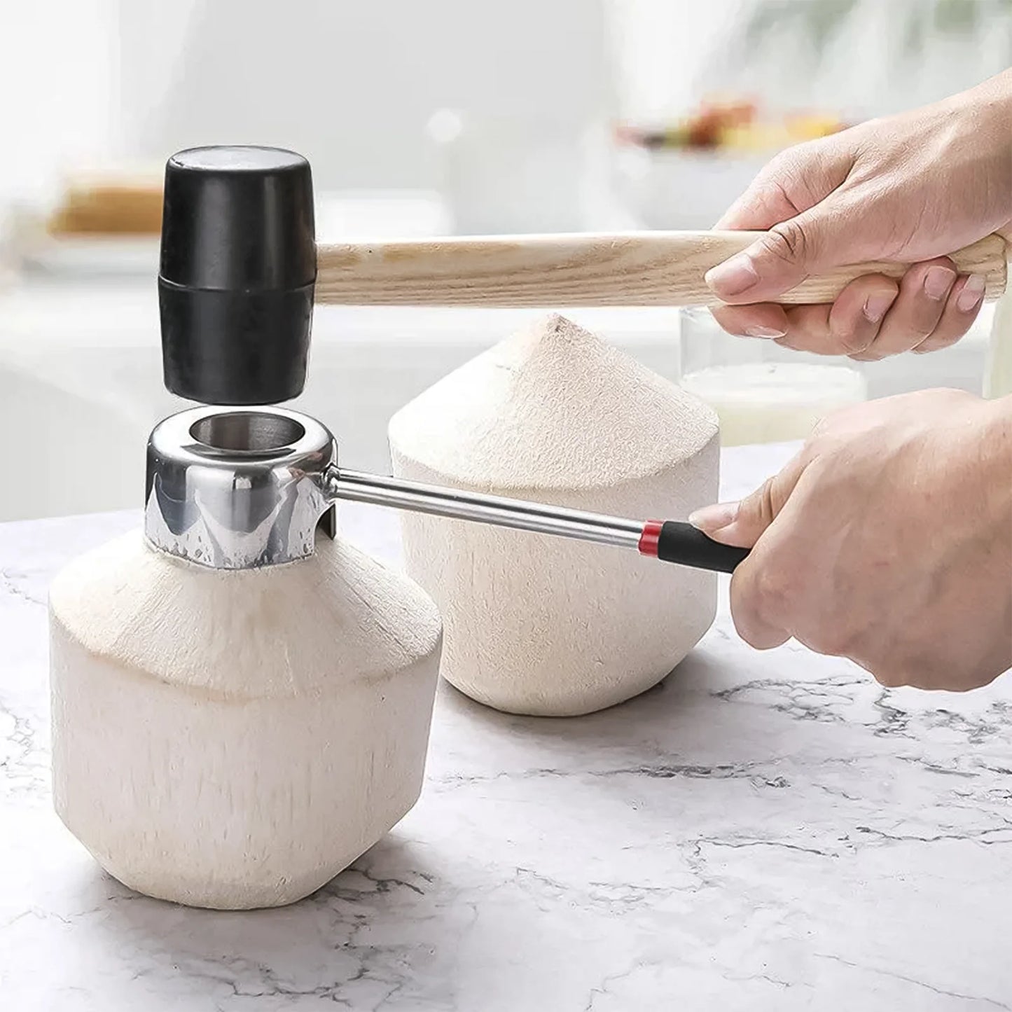 Using stainless steel coconut opener and rubber mallet to open a fresh young coconut