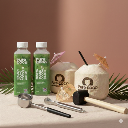 Pure Coco Try Me Pack with frozen young coconut water bottles, fresh whole coconuts and stainless steel coconut opening tools on display